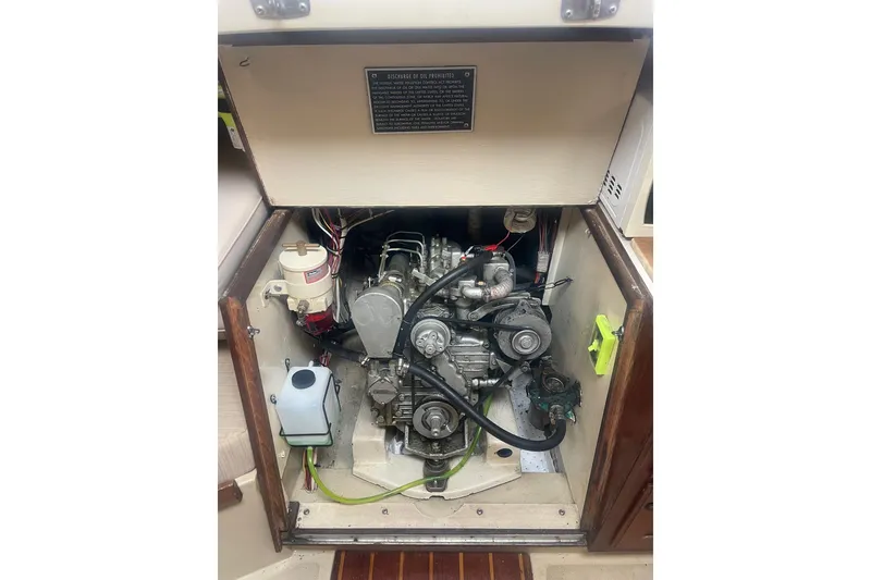 Slide: The Image of Engine compartment of a 1982 O'Day 34 sailboat, showcasing mechanical components and wiring. - 41
