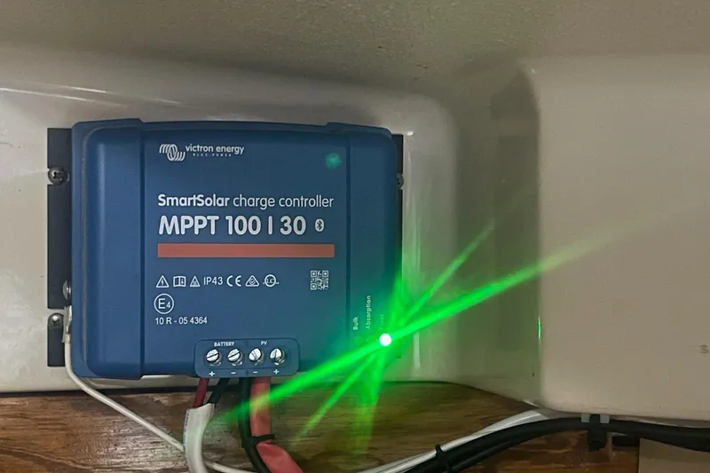 Slide: The Image of Victron Energy SmartSolar charge controller with green LED, installed on 1982 O'Day 34 sailboat. - 42