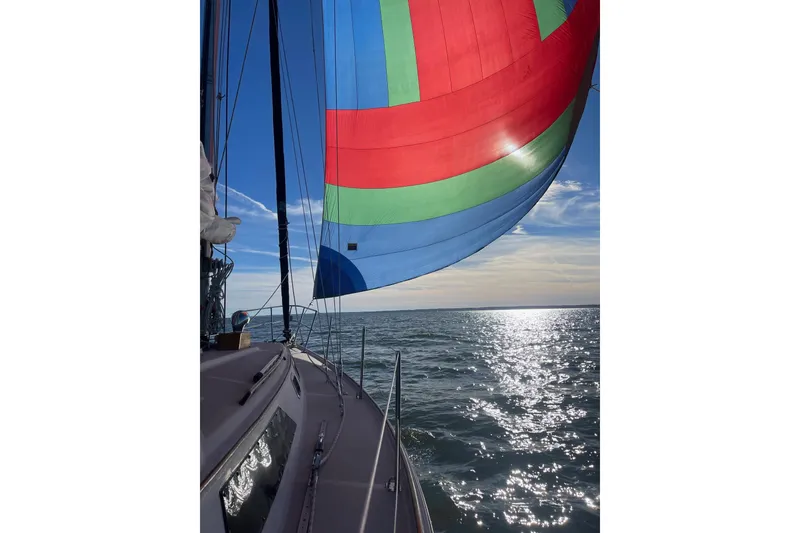 Slide: The Image of 1982 O'Day 34 sailboat with colorful spinnaker on open water, sunny day. - 5