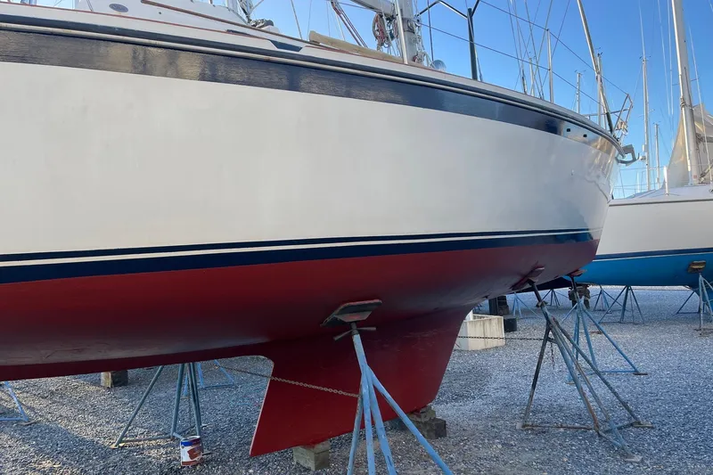 Slide: The Image of 1982 O'Day 34 sailboat on stands, red hull, white and blue trim. - 6