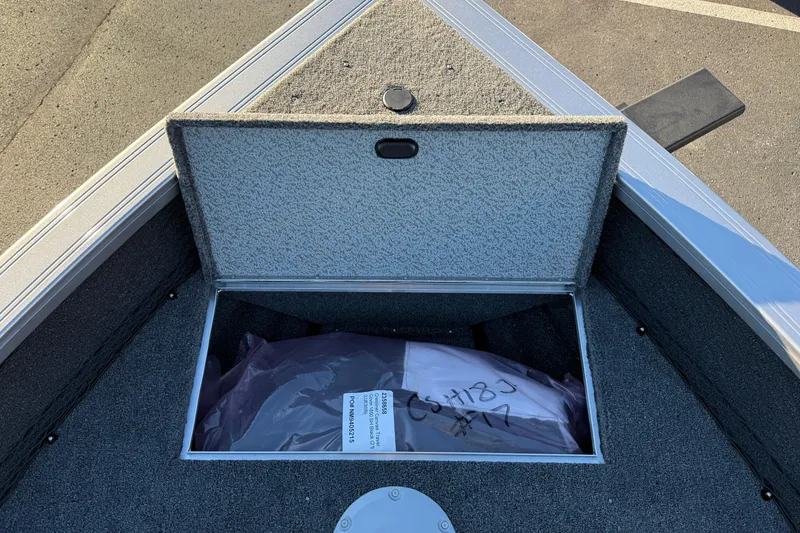 Slide: The Image of Open storage compartment on 2026 Crestliner 1850 Super Hawk boat, showing interior details. - 15