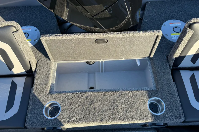Slide: The Image of 2026 Crestliner 1850 Super Hawk boat interior with open storage compartment and cup holders. - 22