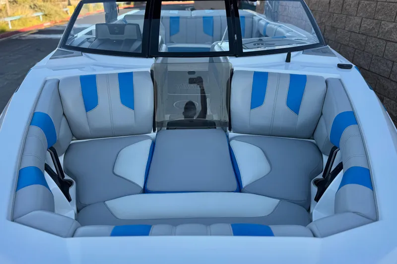 Slide: The Image of 2023 Malibu Wakesetter 21 LX boat interior with blue and gray seating. - 11