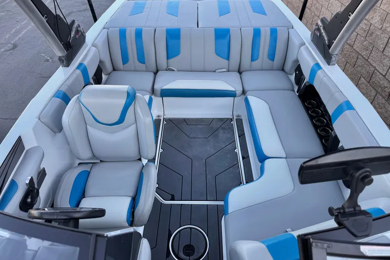 Slide: The Image of 2023 Malibu Wakesetter 21 LX interior with blue and gray seating, modern design. - 16