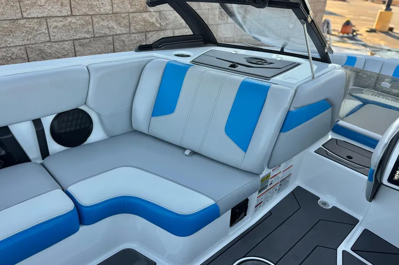 Slide: The Image of 2023 Malibu Wakesetter 21 LX interior with blue and gray seating. - 21