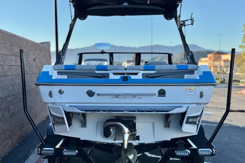 Slide: The Image of 2023 Malibu Wakesetter 21 LX boat, rear view, parked outdoors. - 3