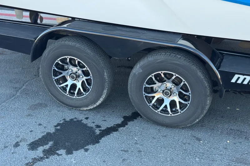Slide: The Image of Trailer wheels of 2023 Malibu Wakesetter 21 LX on pavement. - 35