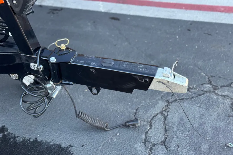 Slide: The Image of Trailer hitch of 2023 Malibu Wakesetter 21 LX on asphalt surface. - 36