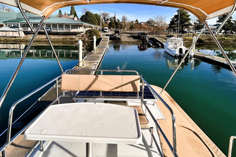 Slide: The Image of 2019 Ranger Tugs R-29 CB docked at marina, sunny day, calm water. - 12