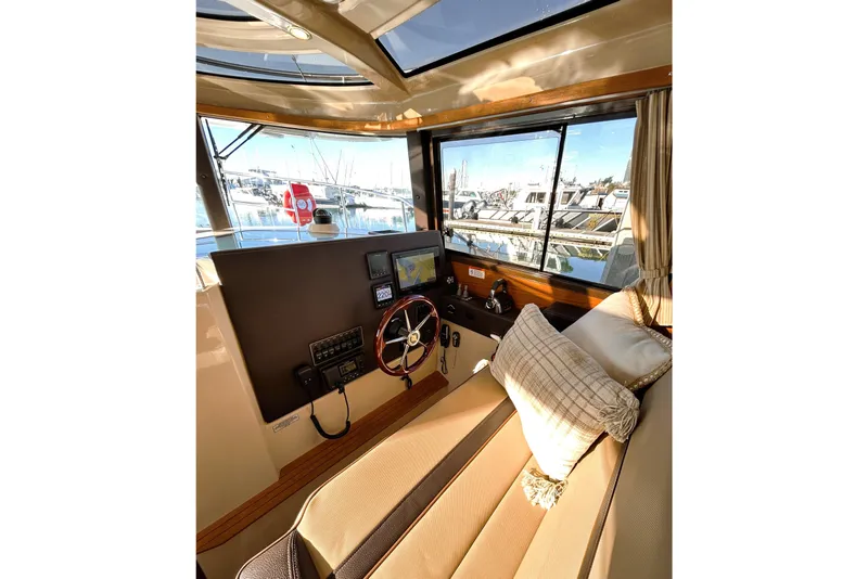 Slide: The Image of Interior of 2019 Ranger Tugs R-29 CB with helm, steering wheel, and navigation equipment. - 16