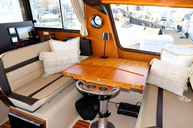Slide: The Image of Interior of 2019 Ranger Tugs R-29 CB with cozy seating and wooden table. - 18