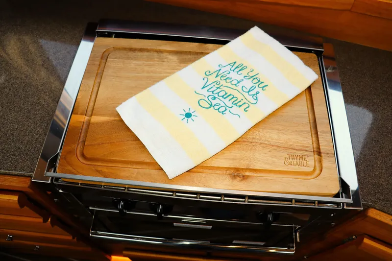 Slide: The Image of Cutting board with towel saying "All You Need Is Vitamin Sea" on Ranger Tugs R-29 CB, 2019. - 20
