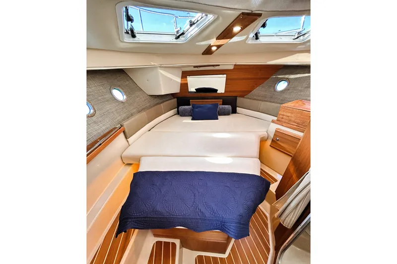Slide: The Image of 2019 Ranger Tugs R-29 CB cabin interior with skylights and cozy bedding. - 21