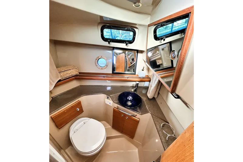 Slide: The Image of 2019 Ranger Tugs R-29 CB bathroom with modern fixtures and porthole window. - 23