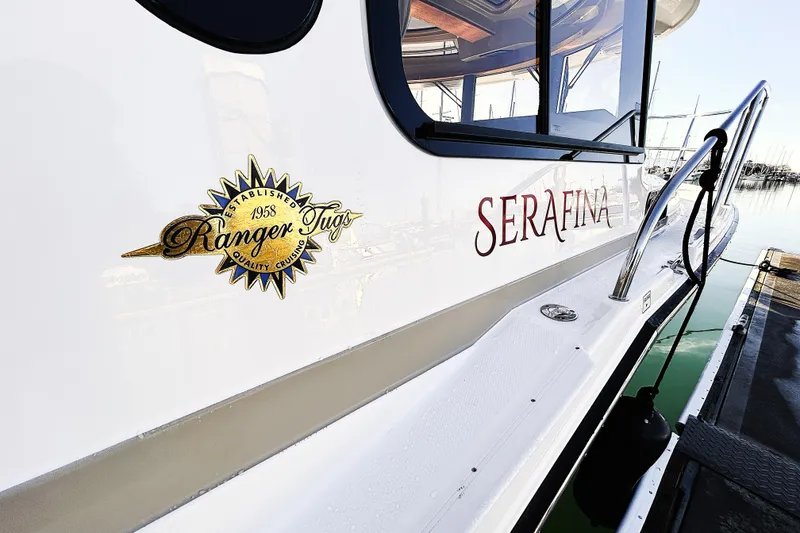 Slide: The Image of 2019 Ranger Tugs R-29 CB boat docked, featuring "Serafina" name and logo. - 24