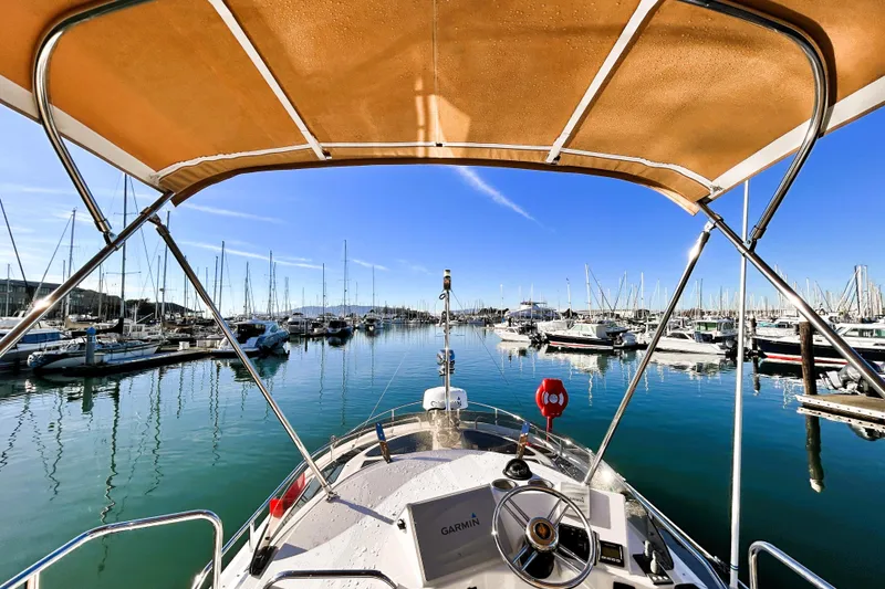 Slide: The Image of 2019 Ranger Tugs R-29 CB boat docked in a marina under clear blue skies. - 9