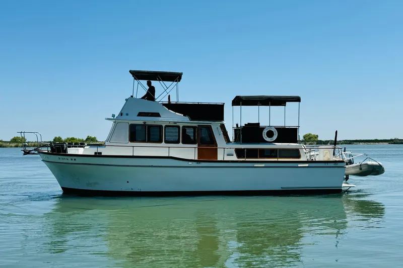 Slide: The Image of 1978 Californian 42 LRC yacht on calm water under clear blue sky. - 1