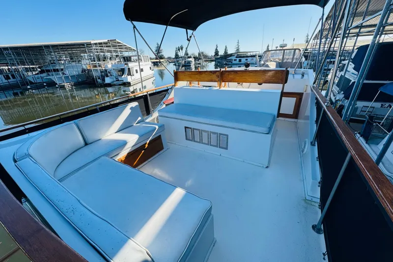 Slide: The Image of 1978 Californian 42 LRC yacht deck with cushioned seating, docked at marina. - 13