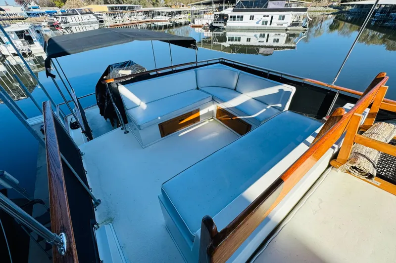 Slide: The Image of 1978 Californian 42 LRC yacht with spacious deck seating, docked at a marina. - 15