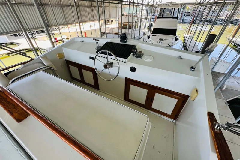 Slide: The Image of 1978 Californian 42 LRC yacht helm with steering wheel and control panel in marina. - 16