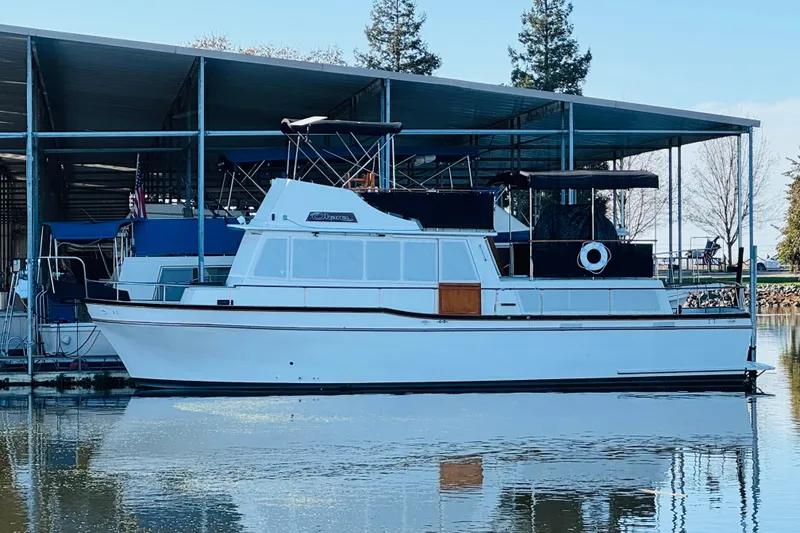 Slide: The Image of 1978 Californian 42 LRC yacht docked in marina, reflecting on calm water. - 2