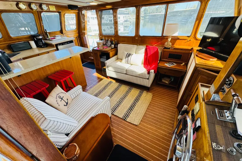 Slide: The Image of Interior of a 1978 Californian 42 LRC yacht with cozy seating and nautical decor. - 23