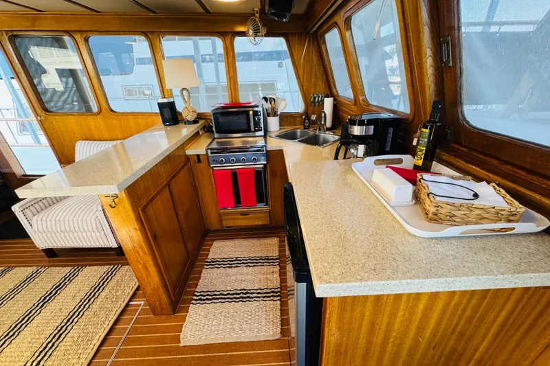 Slide: The Image of 1978 Californian 42 LRC yacht interior with wooden cabinetry and modern kitchen amenities. - 27