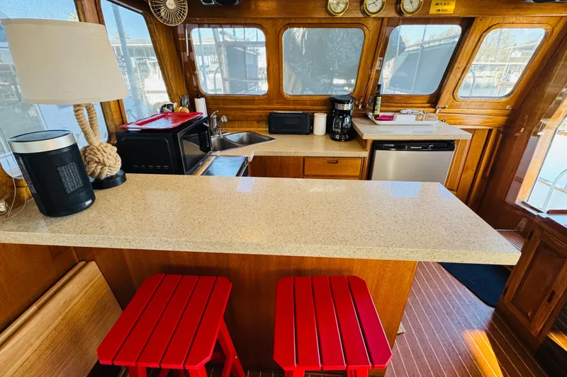 Slide: The Image of 1978 Californian 42 LRC yacht interior with modern kitchen and red stools. - 29