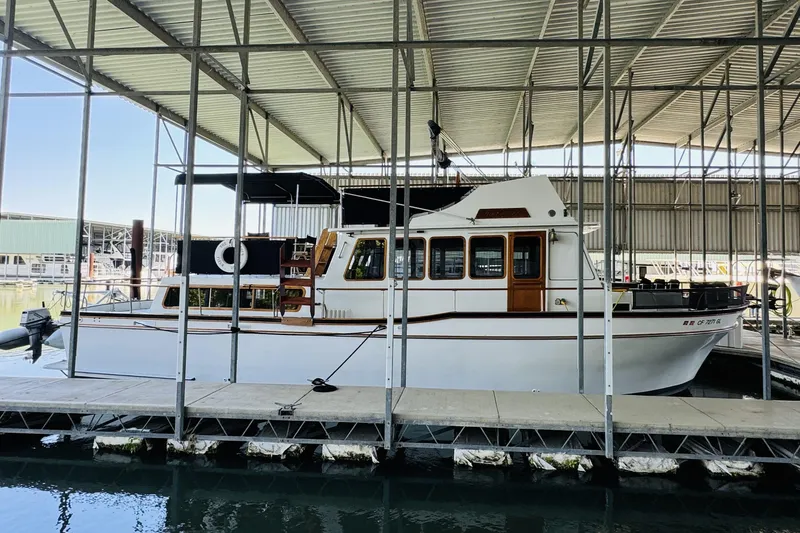 Slide: The Image of 1978 Californian 42 LRC yacht docked in a covered marina. - 3