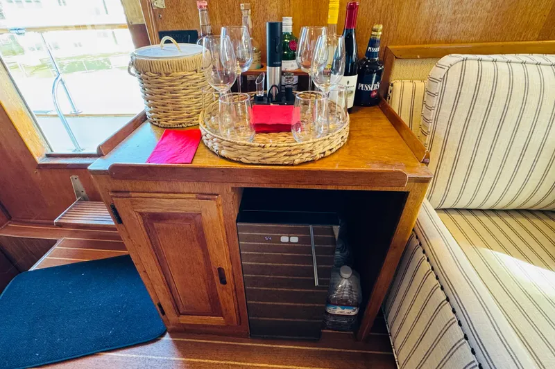 Slide: The Image of 1978 Californian 42 LRC yacht interior with bar setup, wine bottles, and glasses. - 30