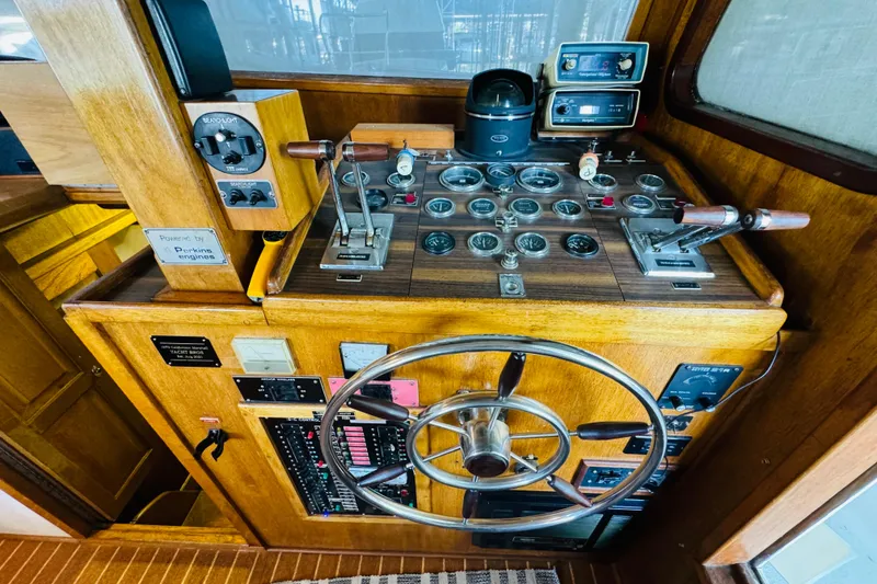Slide: The Image of 1978 Californian 42 LRC yacht helm with vintage controls and wooden dashboard. - 33