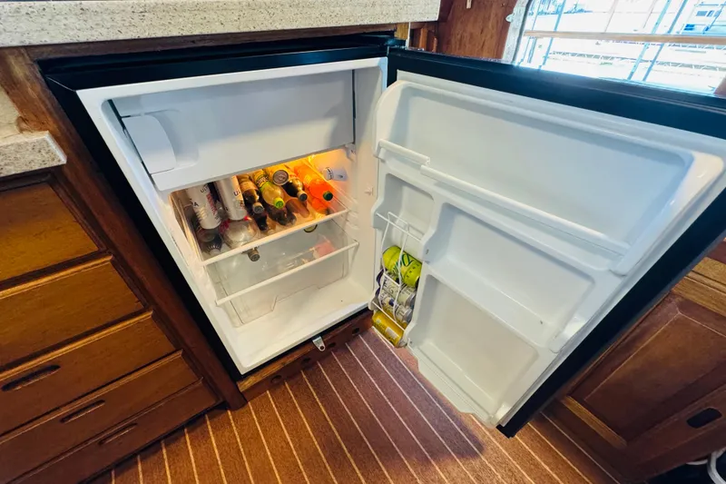 Slide: The Image of Open fridge in 1978 Californian 42 LRC boat, stocked with beverages and condiments. - 34