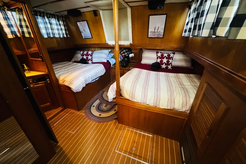 Slide: The Image of 1978 Californian 42 LRC yacht interior with twin beds, wood paneling, and nautical decor. - 38