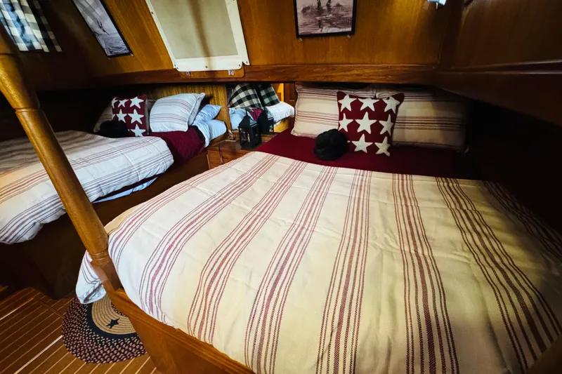Slide: The Image of Cozy cabin interior of 1978 Californian 42 LRC with striped bedding and star-patterned pillows. - 40