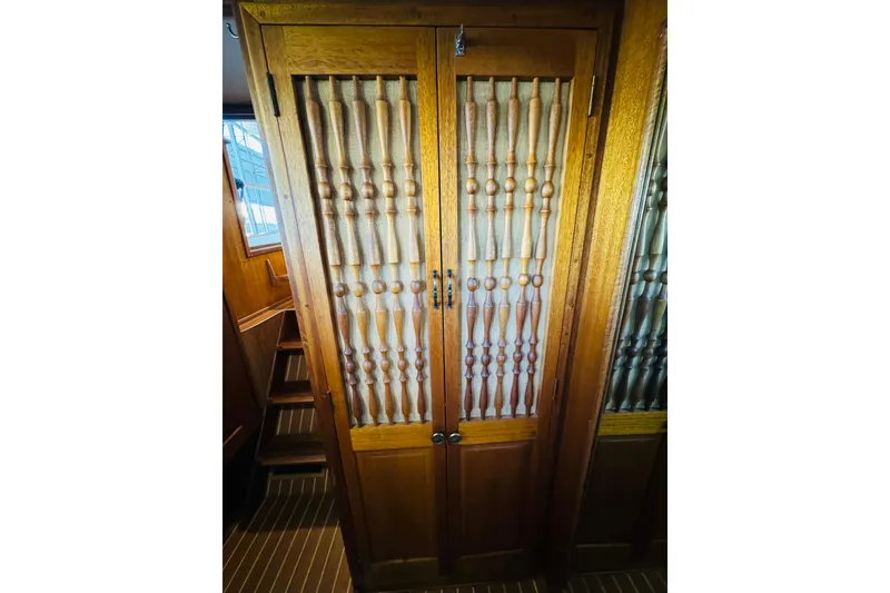 Slide: The Image of Wooden cabinet doors with intricate spindle design on a 1978 Californian 42 LRC yacht. - 42