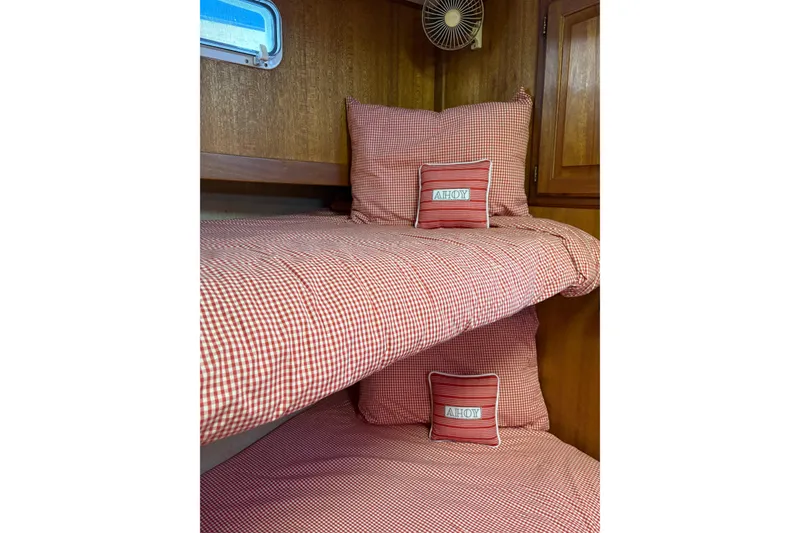 Slide: The Image of Cozy cabin bunk beds with red checkered bedding on a 1978 Californian 42 LRC boat. - 45