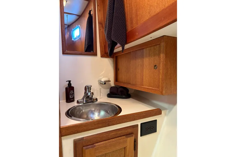Slide: The Image of 1978 Californian 42 LRC yacht bathroom with wooden cabinets and stainless steel sink. - 48