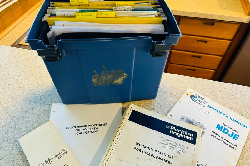 Slide: The Image of Blue box with manuals for 1978 Californian 42 LRC yacht maintenance and engine workshop. - 56