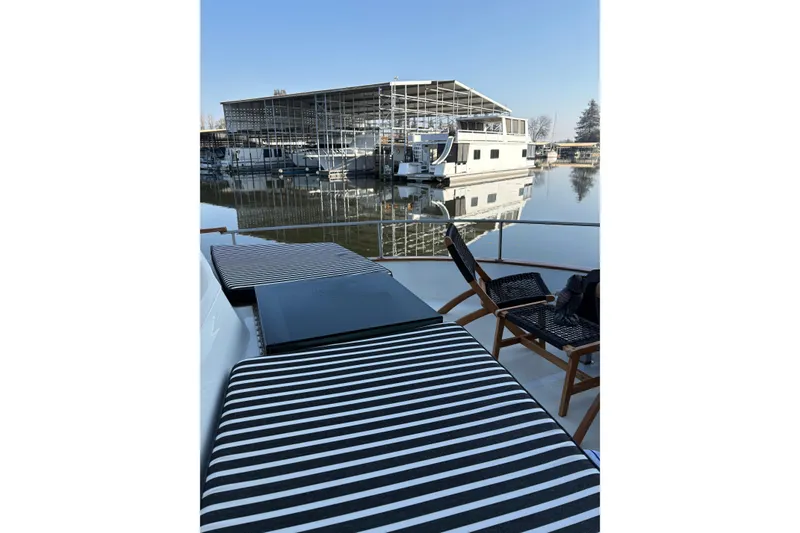 Slide: The Image of 1978 Californian 42 LRC yacht with striped seating, docked near a marina. - 6