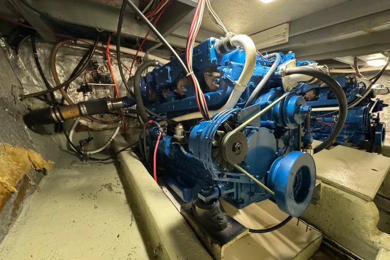 Slide: The Image of Engine room of a 1978 Californian 42 LRC boat, featuring a blue marine engine. - 61