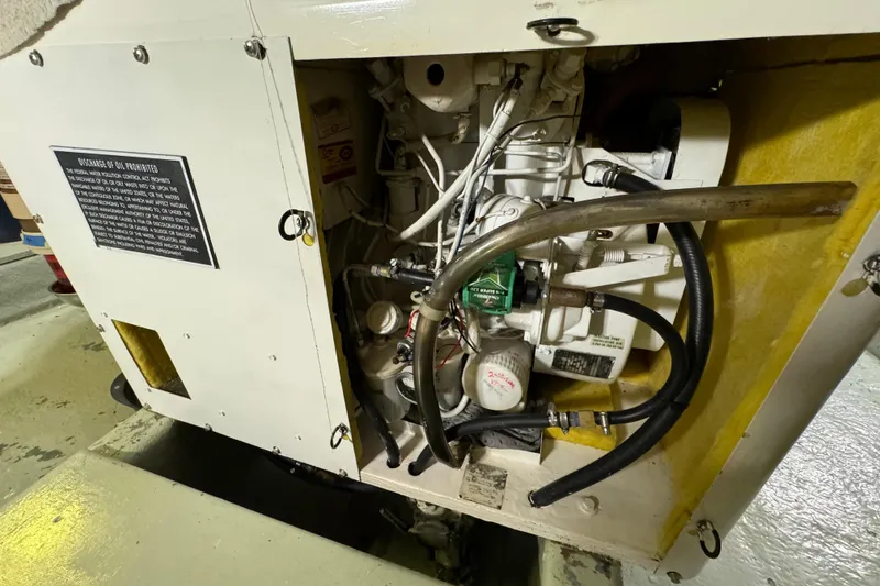 Slide: The Image of Engine compartment of a 1978 Californian 42 LRC boat, showing mechanical components and hoses. - 63