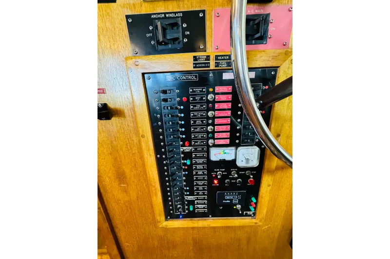 Slide: The Image of Electrical control panel of a 1978 Californian 42 LRC boat, featuring switches and gauges. - 65