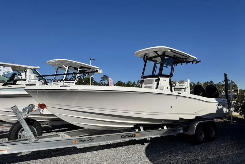 The Image of 2026 Caymas 281 HB boat on trailer under clear blue sky. - 1