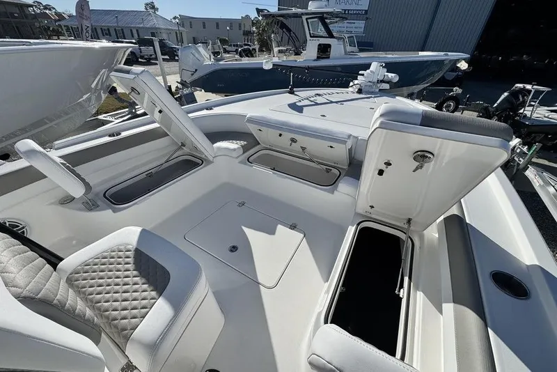 Slide: The Image of 2026 Caymas 281 HB boat interior with open storage compartments and seating. - 13