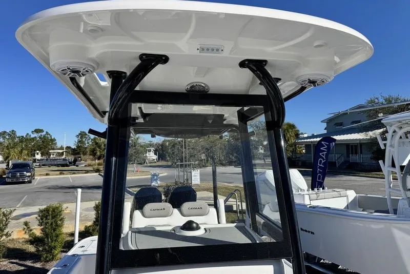 Slide: The Image of 2026 Caymas 281 HB boat with T-top and seating, displayed outdoors. - 15
