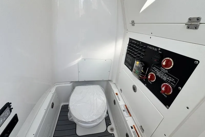 Slide: The Image of 2026 Caymas 281 HB boat interior with toilet and control panel. - 17