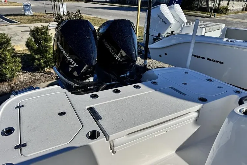 Slide: The Image of 2026 Caymas 281 HB boat with dual Mercury engines, docked outdoors. - 24