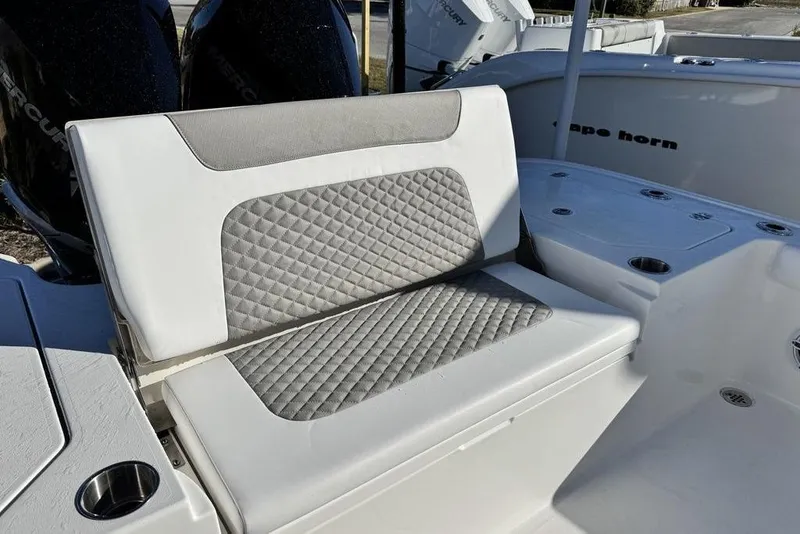 Slide: The Image of 2026 Caymas 281 HB boat with cushioned seating and dual Mercury engines. - 25