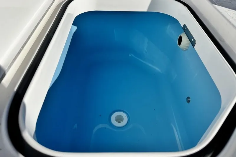 Slide: The Image of Livewell compartment in 2026 Caymas 281 HB boat, featuring a blue interior. - 26