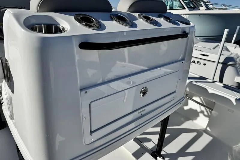 Slide: The Image of 2026 Caymas 281 HB boat console with cup holders and storage compartment. - 28